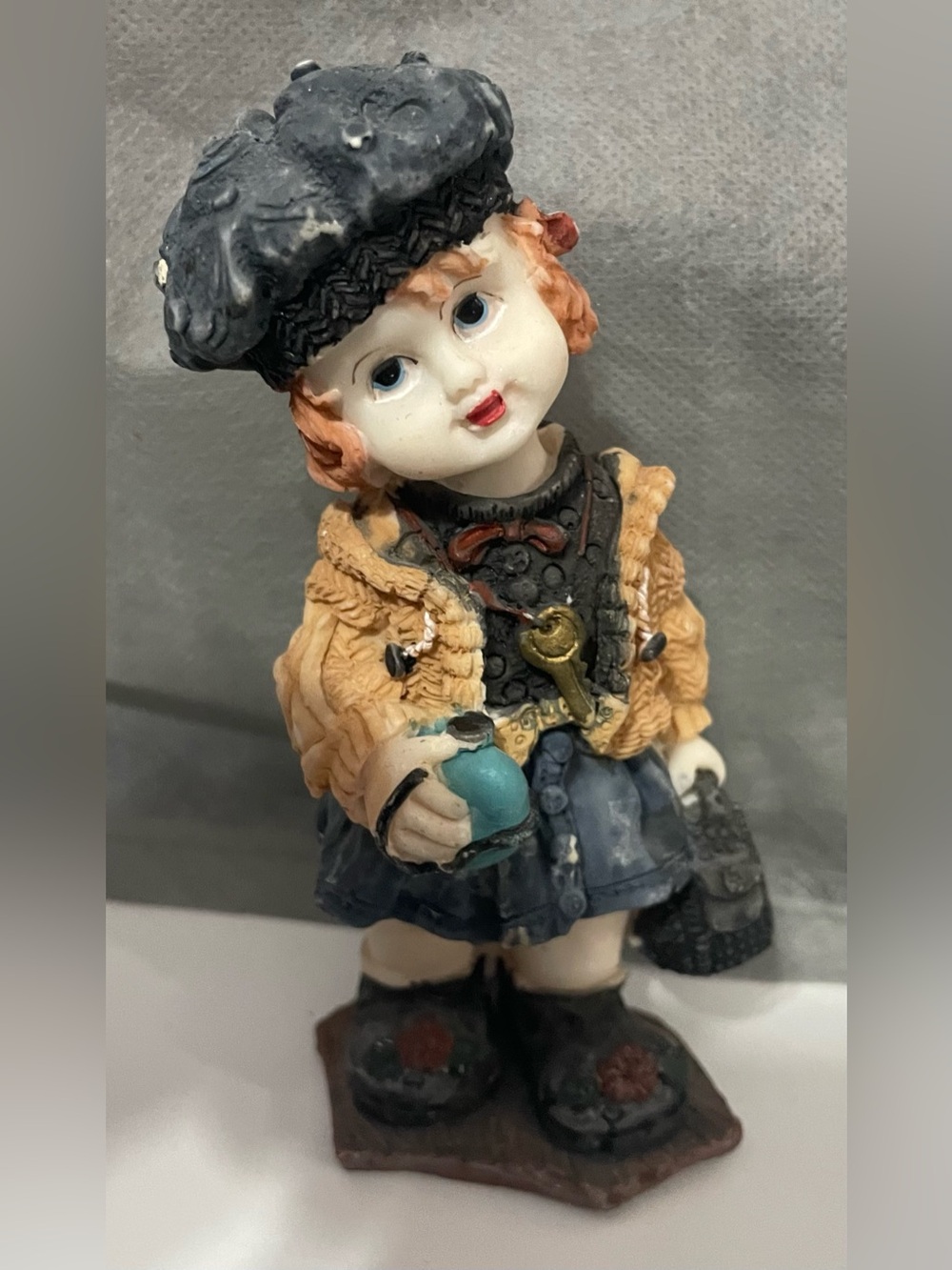 Hand-Painted Ceramic Girl Figurine in Black, Tan, and Blue